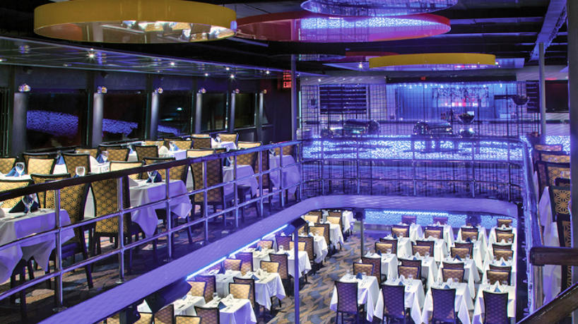 Elegant yacht dining deck with multi-level seating and ambient lighting.